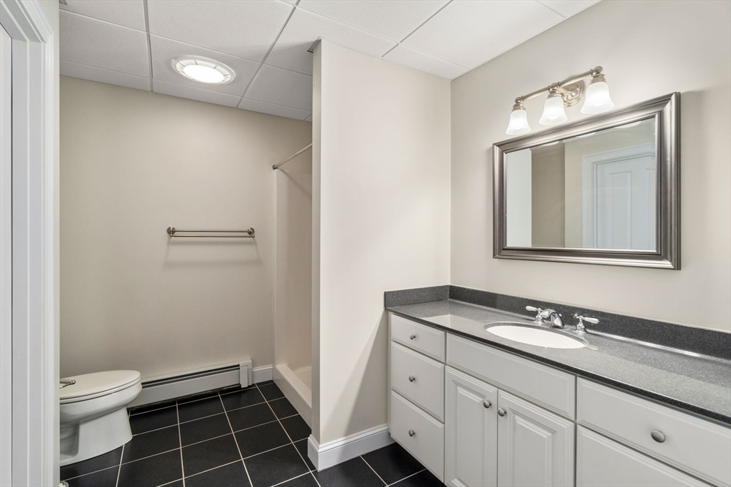 40 Sandy Ridge Road Sterling, MA 01564 - Photo 23 of 33 a bathroom with a granite countertop sink a toilet and a mirror