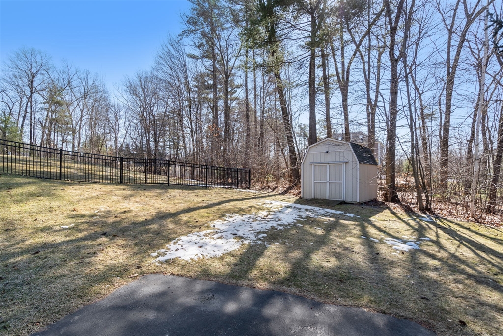 40 Sandy Ridge Road Sterling, MA 01564 - Photo 31 of 33 a view of backyard with wooden fence and large trees
