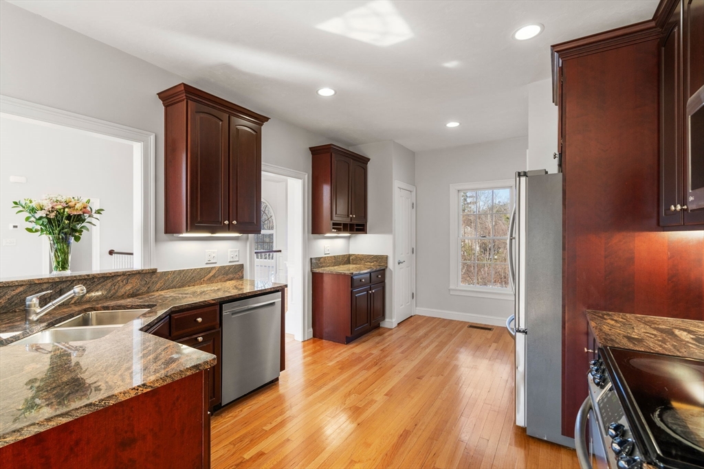 40 Sandy Ridge Road Sterling, MA 01564 - Photo 7 of 33 a kitchen with a sink stove and cabinets