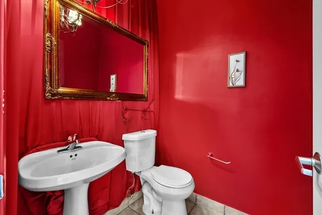 a bathroom with a sink a toilet and mirror