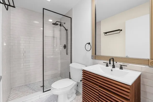 a bathroom with a sink toilet and shower