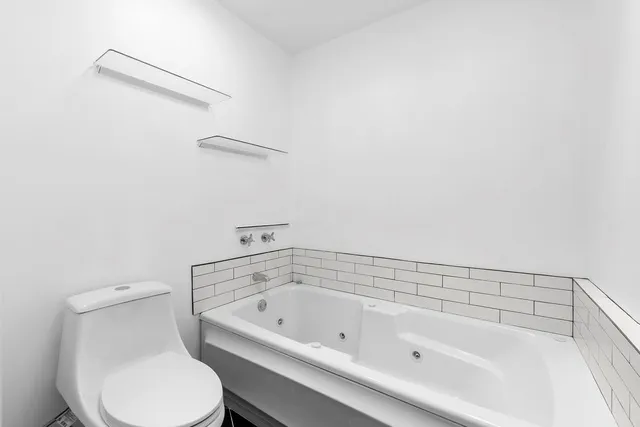 a bathroom with a toilet and a bathtub