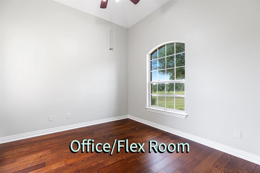 237 Cardinal Drive Paige, TX 78659 - Photo 18 of 37 Empty room with dark wood finished floors, a ceiling fan, and lofted ceiling