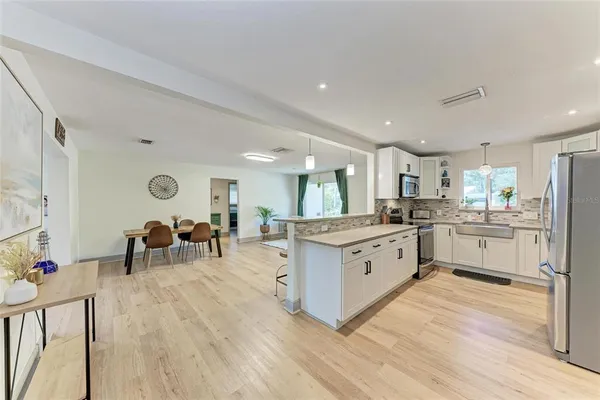 a kitchen with white cabinets and counter space