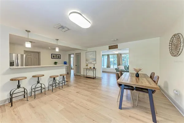 a living room with furniture a wooden floor and a sink