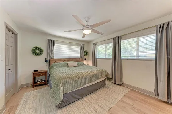 a bedroom with a large bed and a chandelier