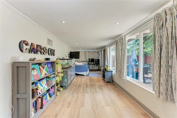 a living room with lots of furniture and a book shelf