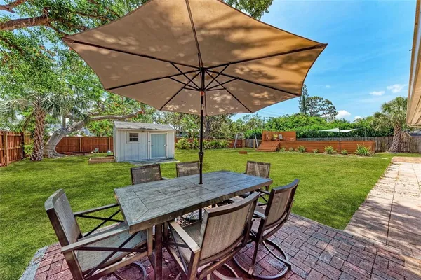 a view of yard with patio