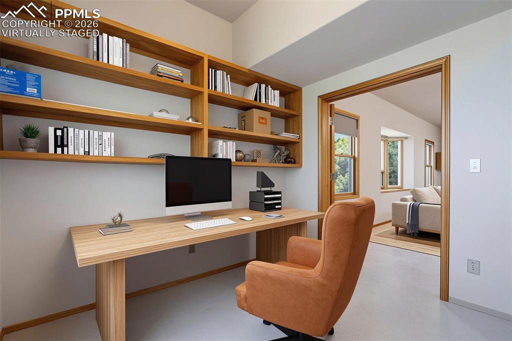 2550 Slocum Road Peyton, CO 80831 - Photo 31 of 50 virtually staged Built-in wooden shelving and desk unit provides functional workspace