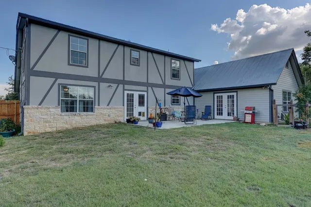 a view of a house with backyard porch and sitting area