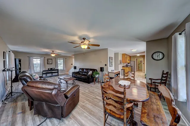 a living room with fireplace furniture and a wooden floor