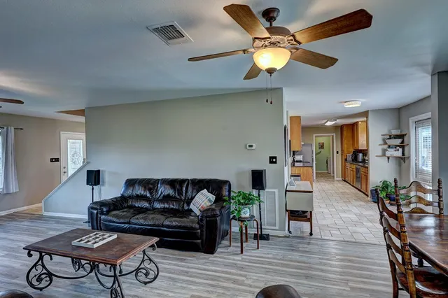 a living room with furniture and wooden floor
