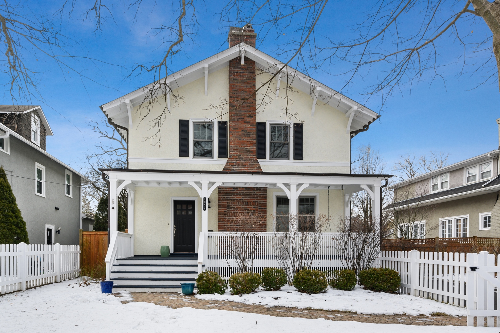 1054 Tower Road Winnetka, IL 60093 - Photo 1 of 32 a front view of a house with a yard