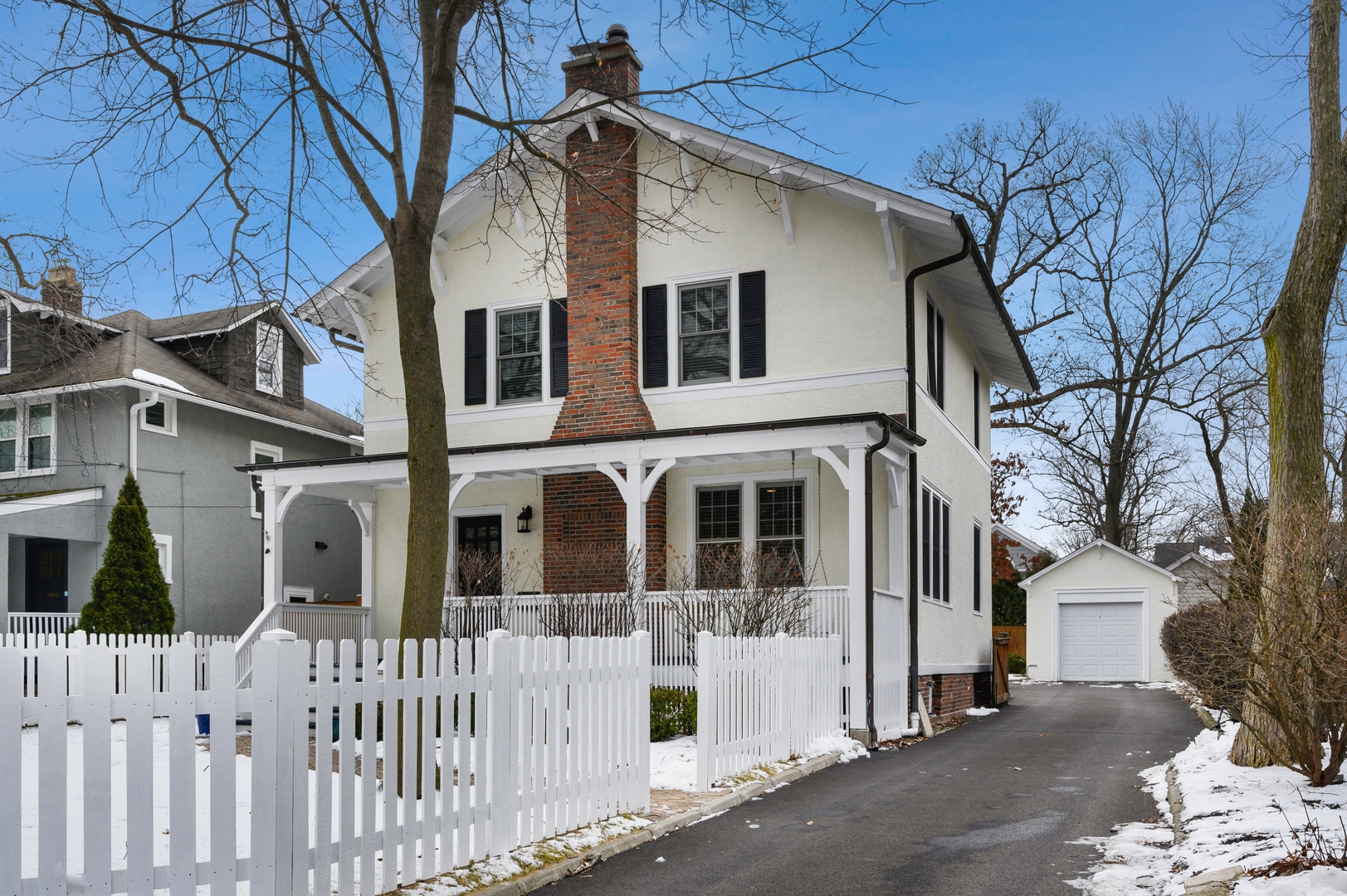 1054 Tower Road Winnetka, IL 60093 - Photo 2 of 32 a front view of a house with a small yard