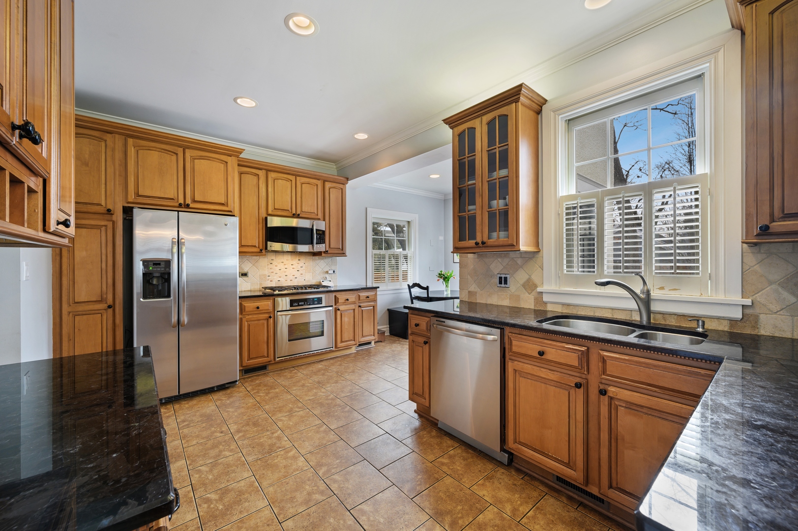 1054 Tower Road Winnetka, IL 60093 - Photo 12 of 32 a kitchen with stainless steel appliances granite countertop a stove a sink dishwasher a refrigerator and a oven