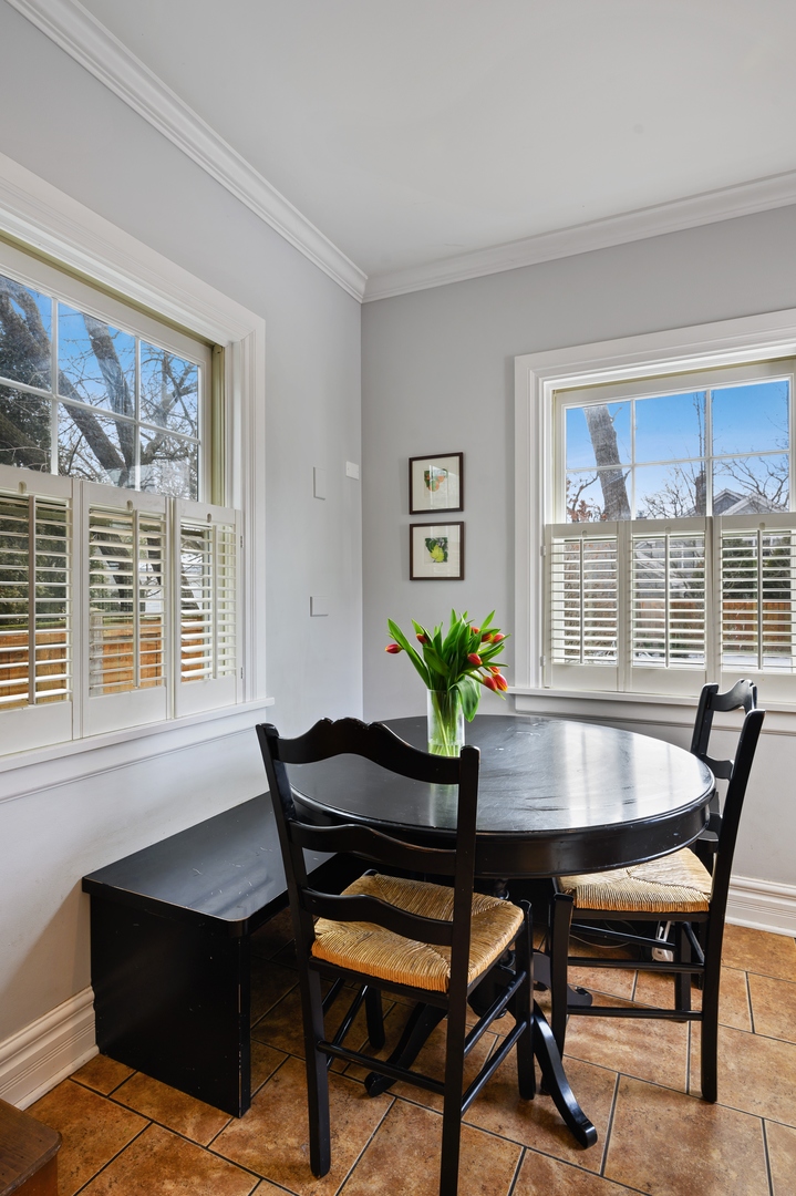 1054 Tower Road Winnetka, IL 60093 - Photo 14 of 32 a view of a dining room with furniture and a window