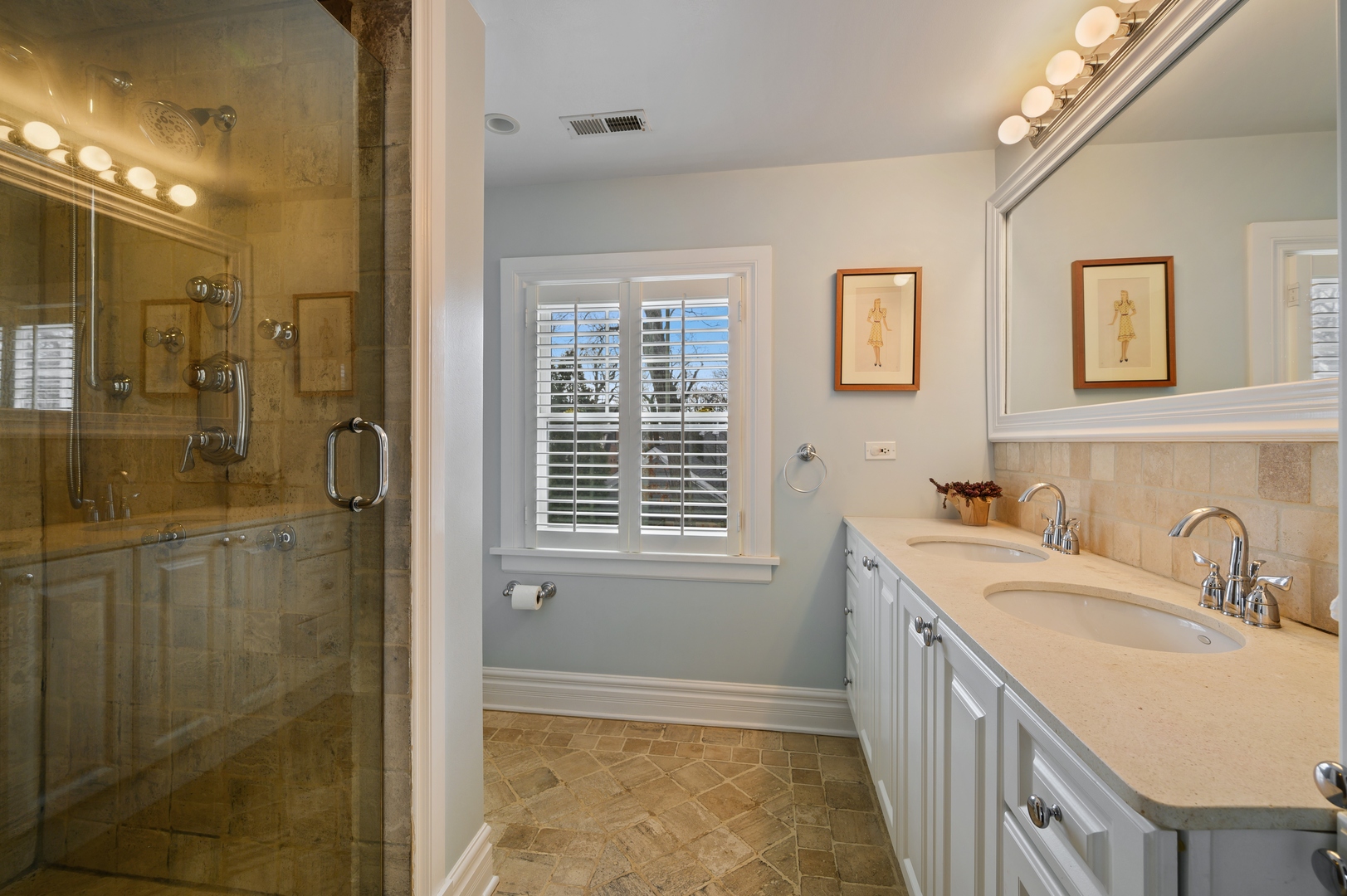 1054 Tower Road Winnetka, IL 60093 - Photo 19 of 32 a bathroom with a sink a shower and a mirror