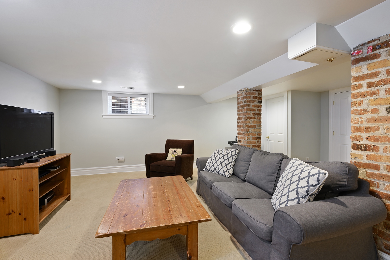 1054 Tower Road Winnetka, IL 60093 - Photo 26 of 32 a living room with furniture and a flat screen tv