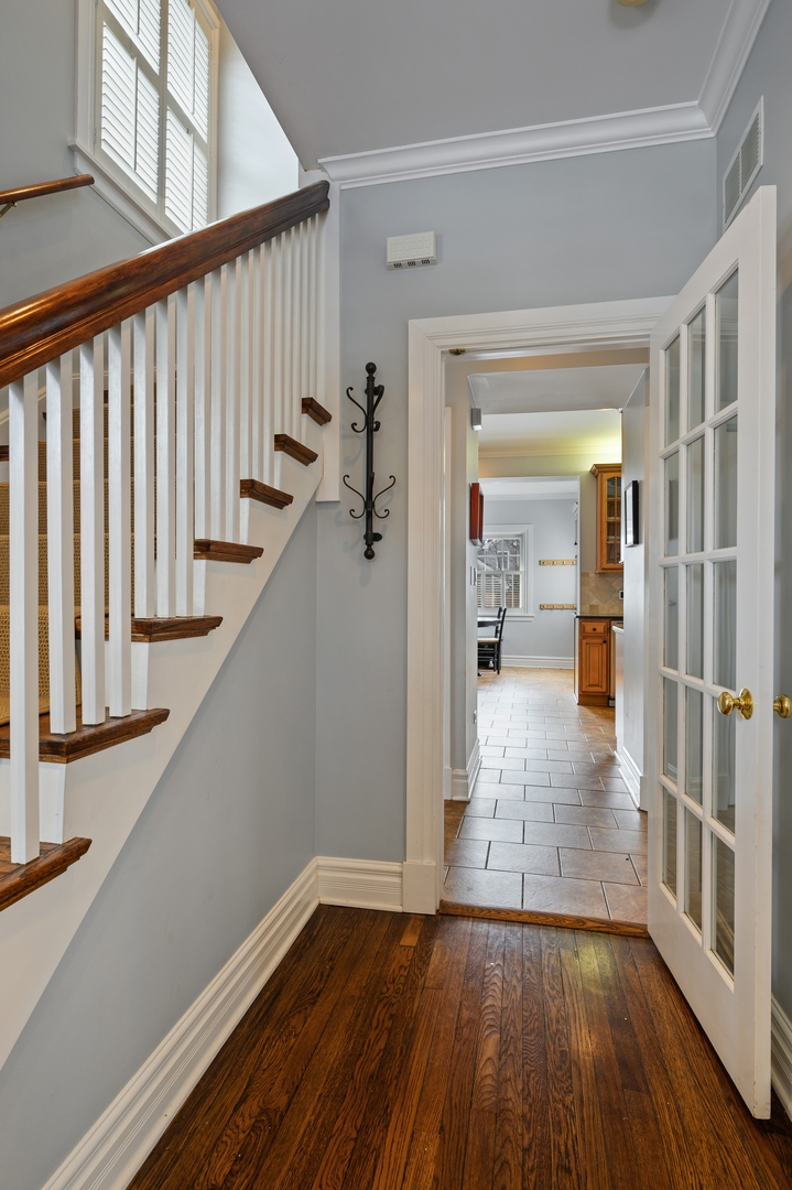 1054 Tower Road Winnetka, IL 60093 - Photo 5 of 32 a view of entryway with wooden floor and stairs