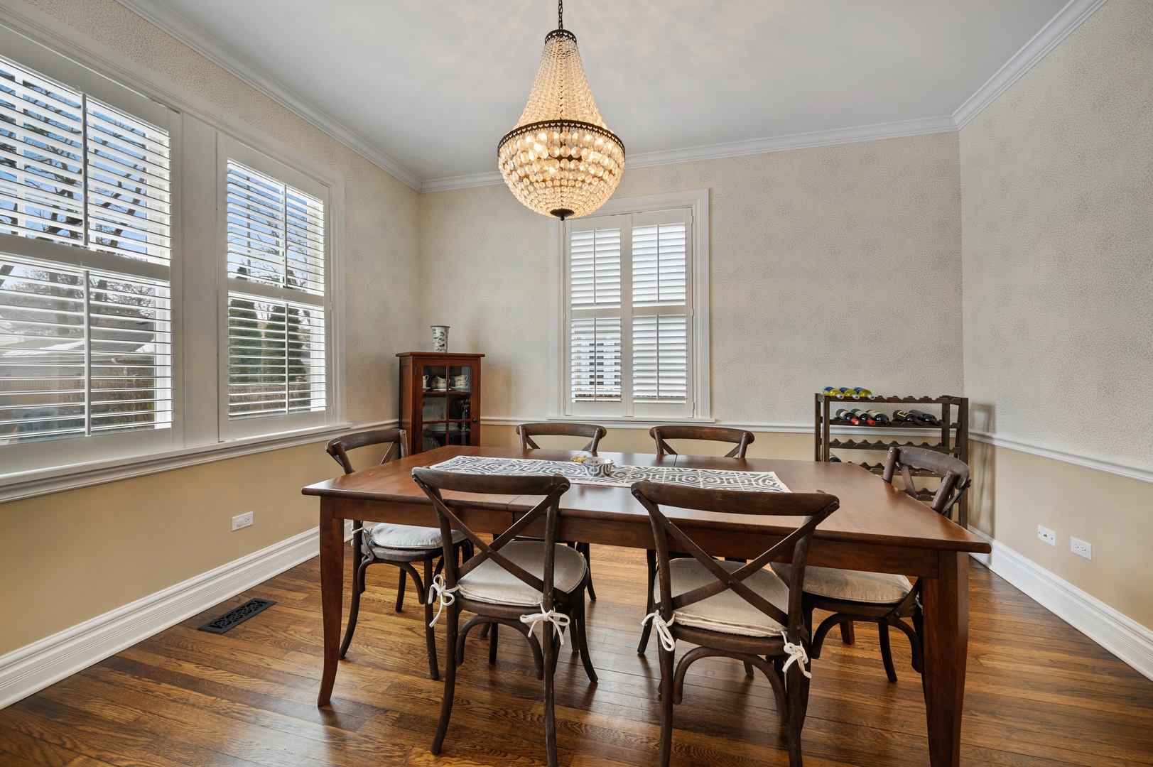 1054 Tower Road Winnetka, IL 60093 - Photo 10 of 32 a view of a dining room with furniture a chandelier and wooden floor