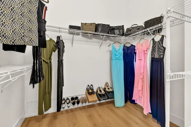 a living room with couches a fireplace with wooden floor