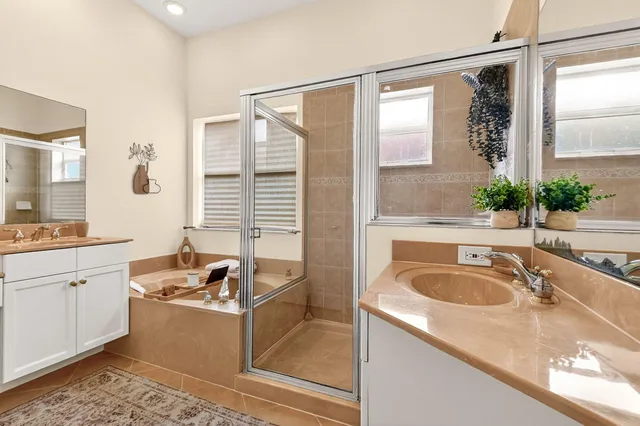 a view of a house with a yard and palm trees