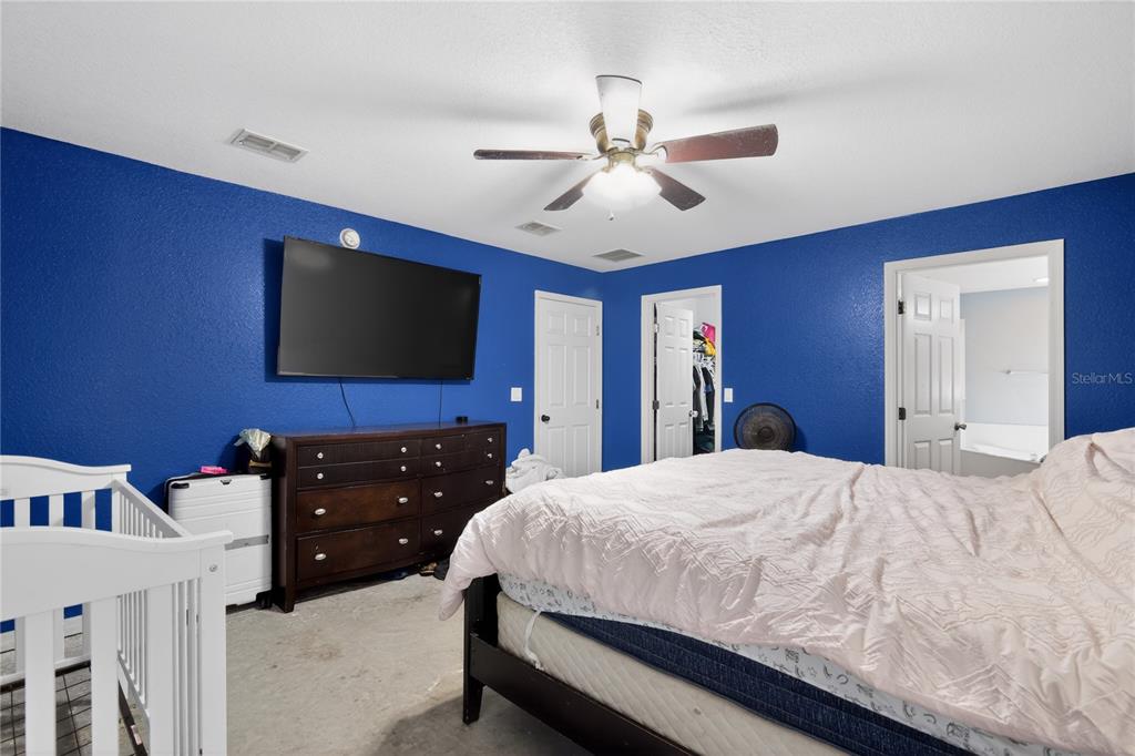 105 Pecan Pass Ocala, FL 34472 - Photo 14 of 25 a bedroom with a bed and a flat screen tv