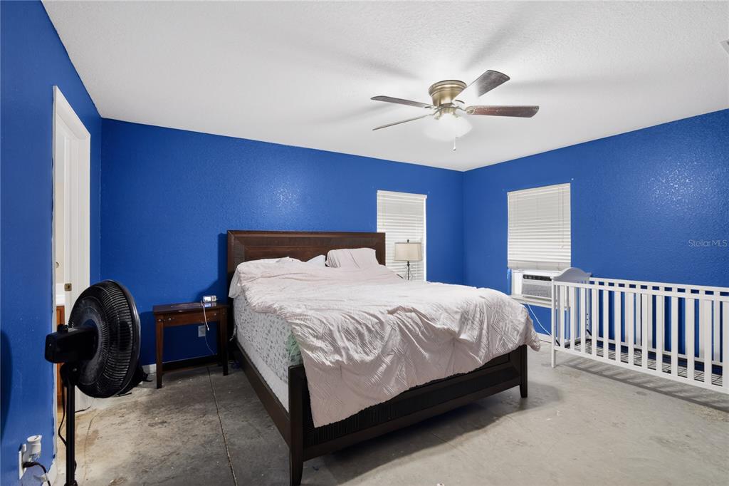 105 Pecan Pass Ocala, FL 34472 - Photo 16 of 25 a bedroom with a bed and a ceiling fan