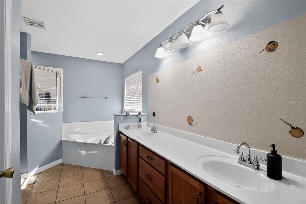 105 Pecan Pass Ocala, FL 34472 - Photo 19 of 25 a bathroom with a sink double vanity and a mirror