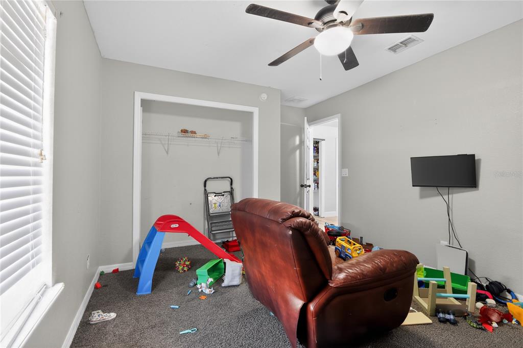 105 Pecan Pass Ocala, FL 34472 - Photo 21 of 25 a living room with furniture and a ceiling fan
