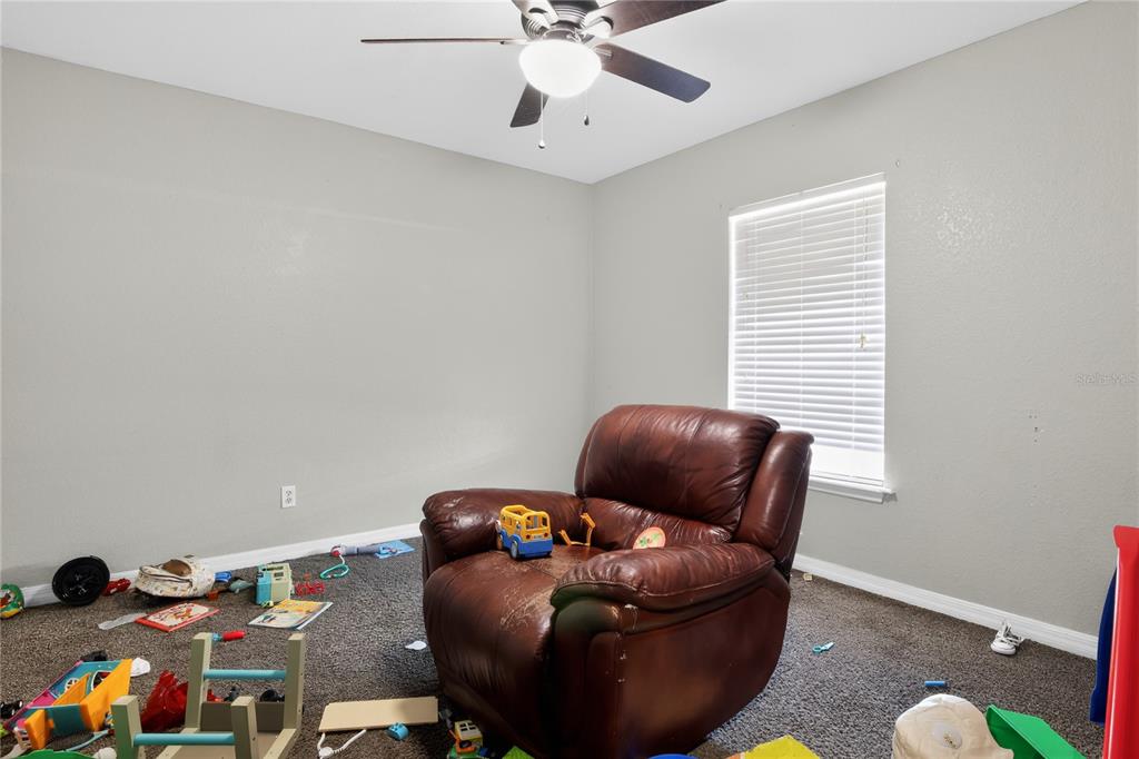 105 Pecan Pass Ocala, FL 34472 - Photo 22 of 25 a living room with furniture and a ceiling fan