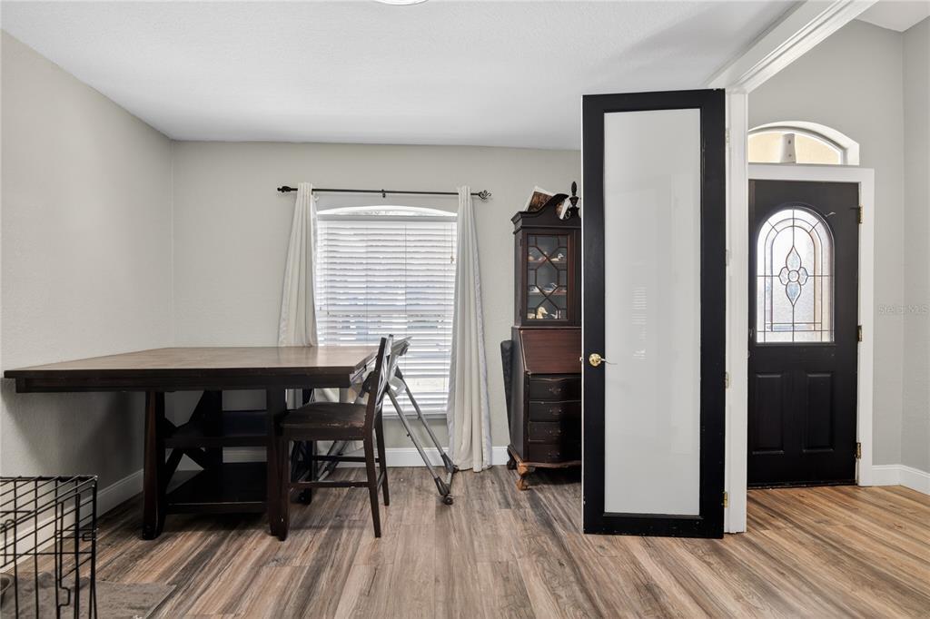 105 Pecan Pass Ocala, FL 34472 - Photo 3 of 25 a view of a dining room with furniture and wooden floor