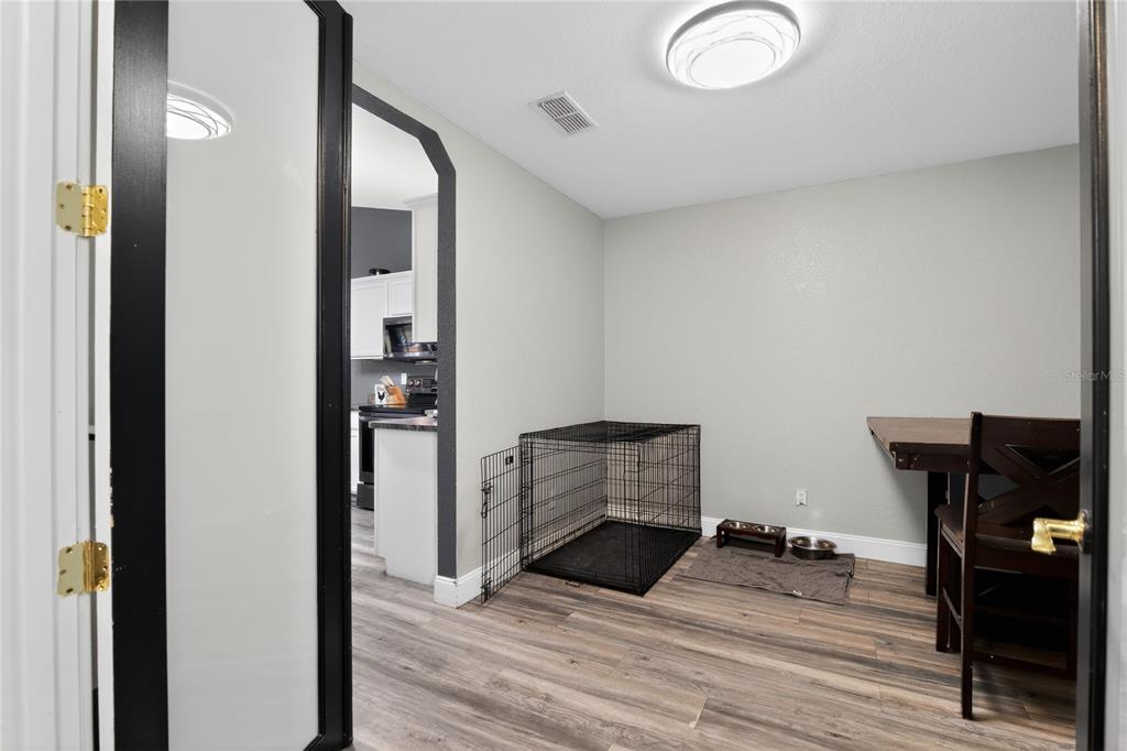 105 Pecan Pass Ocala, FL 34472 - Photo 4 of 25 a view of a hallway with wooden floor and furniture