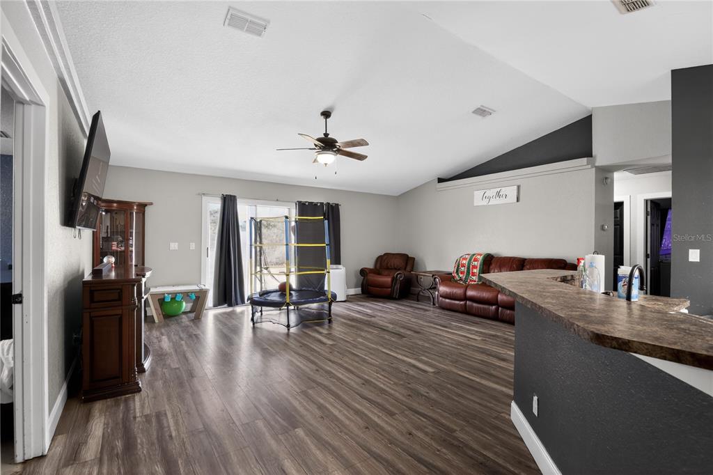 105 Pecan Pass Ocala, FL 34472 - Photo 8 of 25 a living room with furniture and a wooden floor