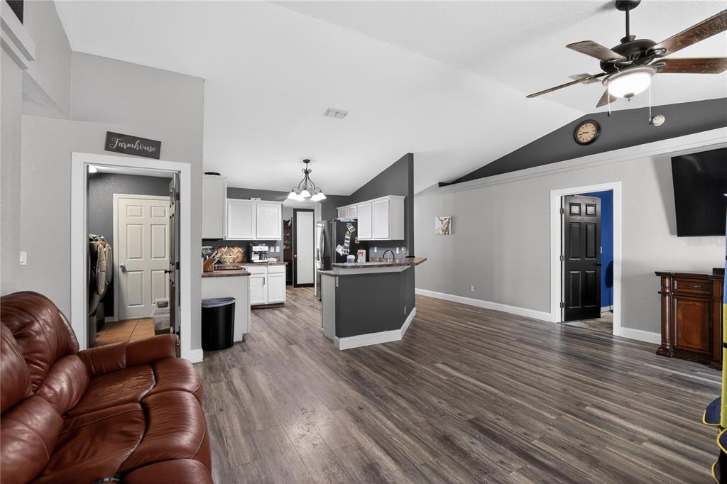 105 Pecan Pass Ocala, FL 34472 - Photo 9 of 25 a kitchen with refrigerator cabinets and wooden floor