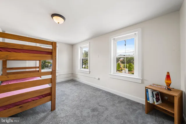 a bedroom with bed and window