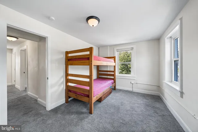 an empty room with windows and closet