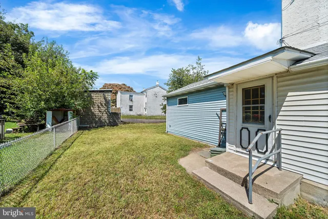 a view of a house with a yard and garage