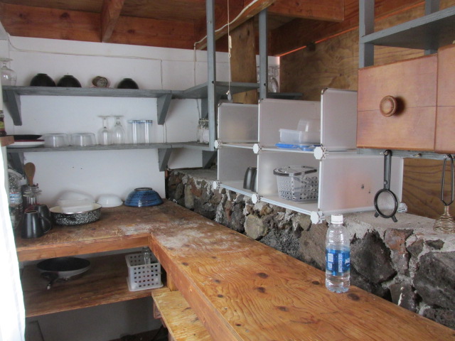 92-8811 Catamaran Lane Ocean View, HI 96704 - Photo 8 of 10 a kitchen with lots of bottles of alcohol