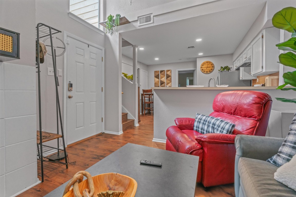 a living room with furniture and a wooden floor