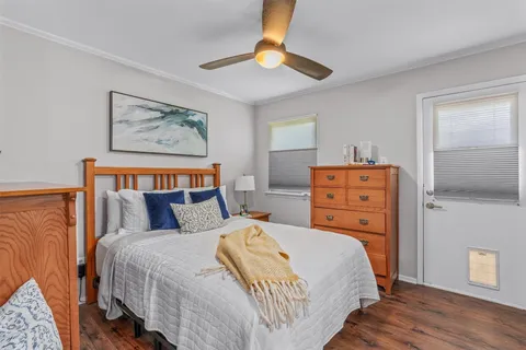 a bedroom with bed and wooden floor