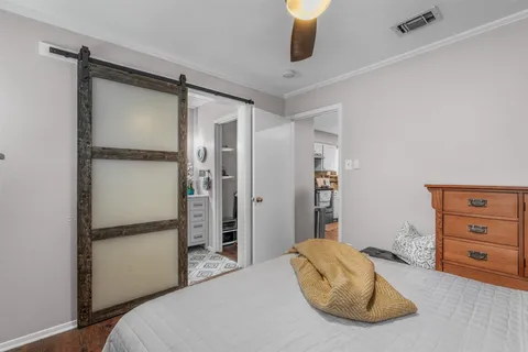 a bedroom with a bed and a walk in closet