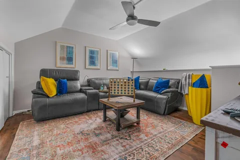 a living room with furniture and a rug