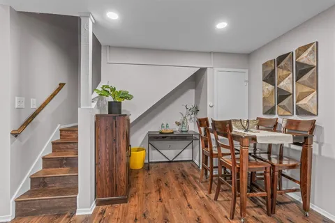 a view of an chairs and table in wooden floor