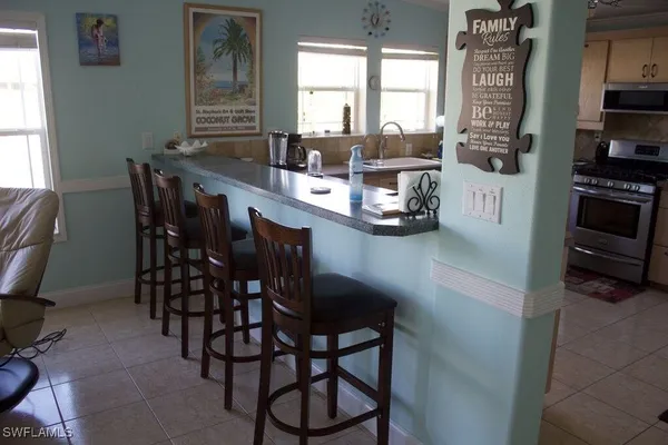 a utility room with dryer washer and a view of living room