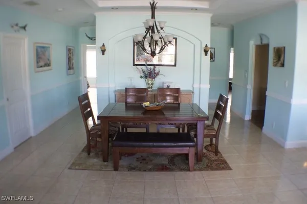 a utility room with stainless steel appliances white cabinets washer and dryer