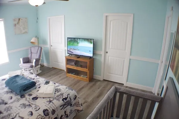 a bedroom with a bed and wooden floor