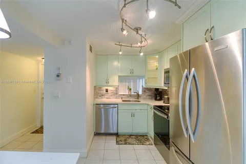 a kitchen with stainless steel appliances a refrigerator sink and microwave