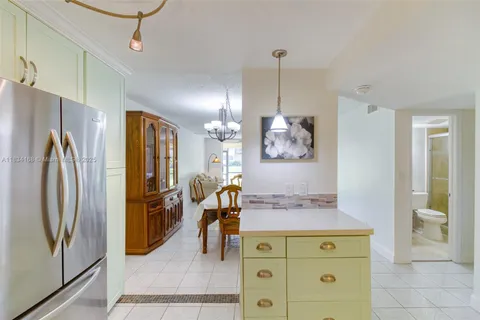 a view of living room with cabinets and a refrigerator