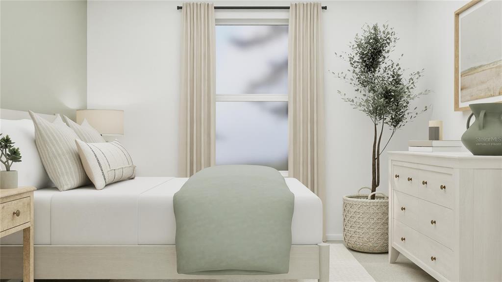 5200 Clay Whaley Road St. Cloud, FL 34772 - Photo 11 of 27 a bedroom with a bed and a potted plant